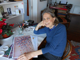 photo of Beatriz Vidal with some of her illustrations for Pine and Winter Sparrow